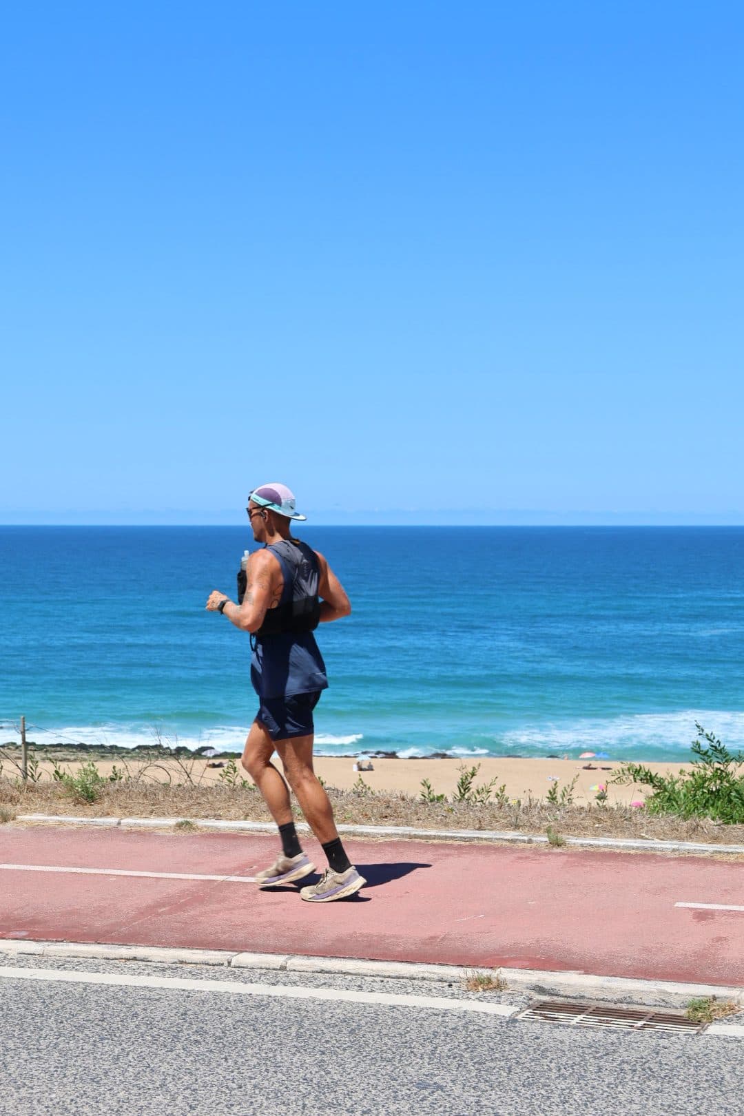Jonathan Fors running a coastal path with the Atlantic behind him.